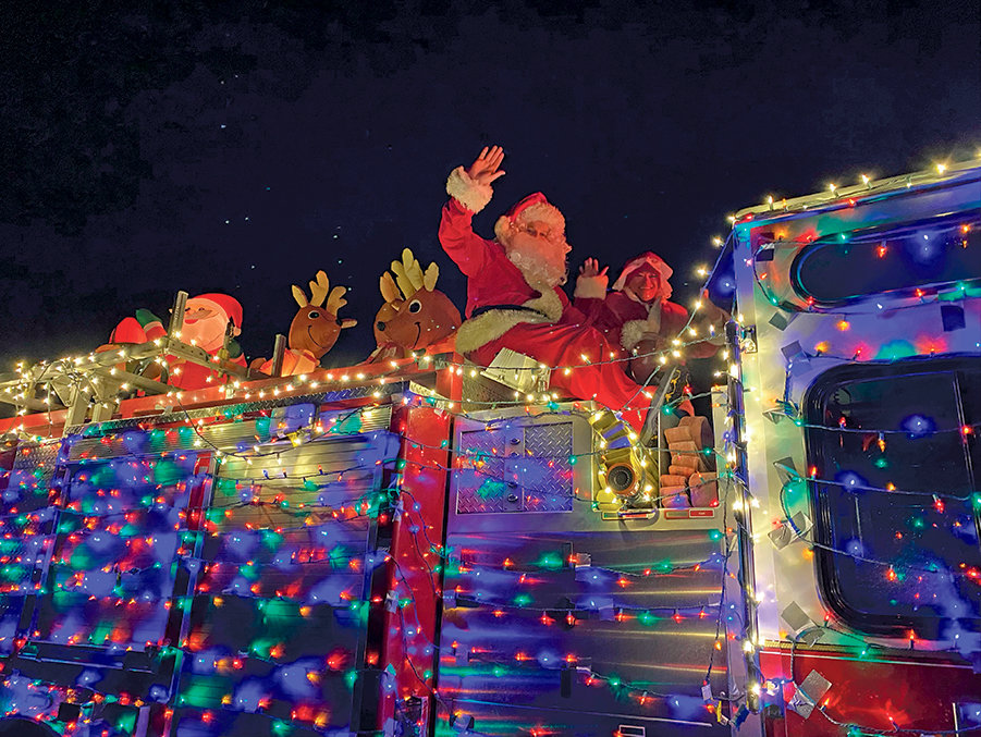 Santa and the Mrs. ride Key Peninsula Fire’s Santa sleigh.